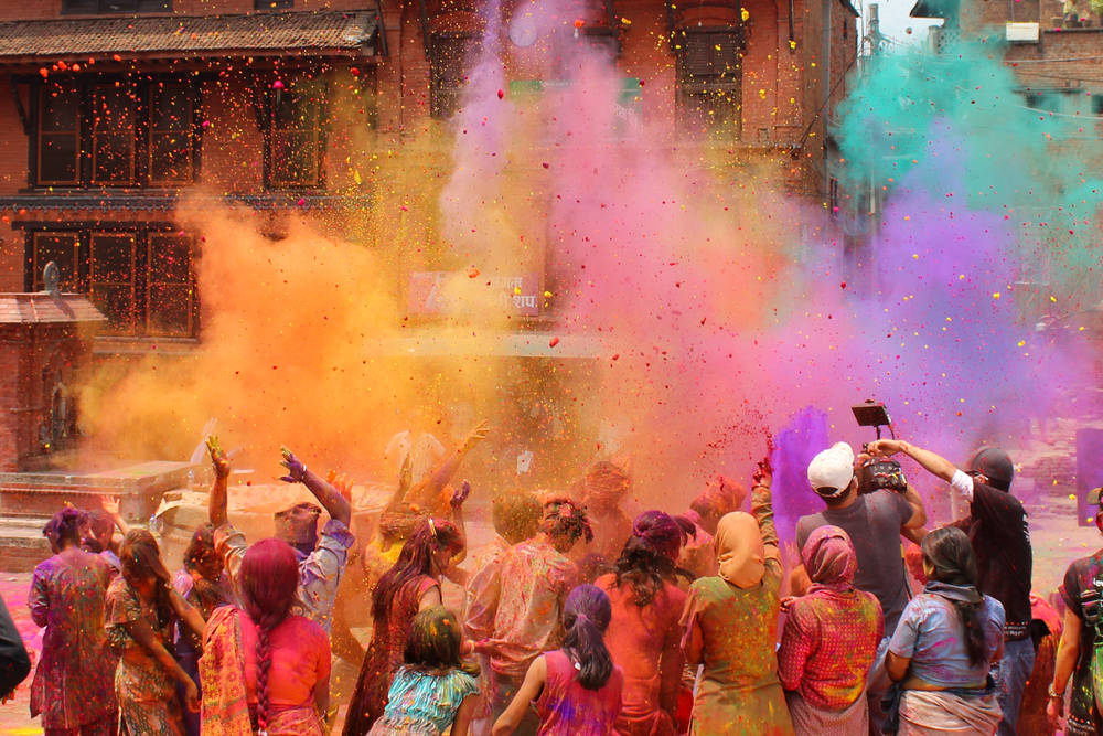 Crowd throws up paint during holi festival