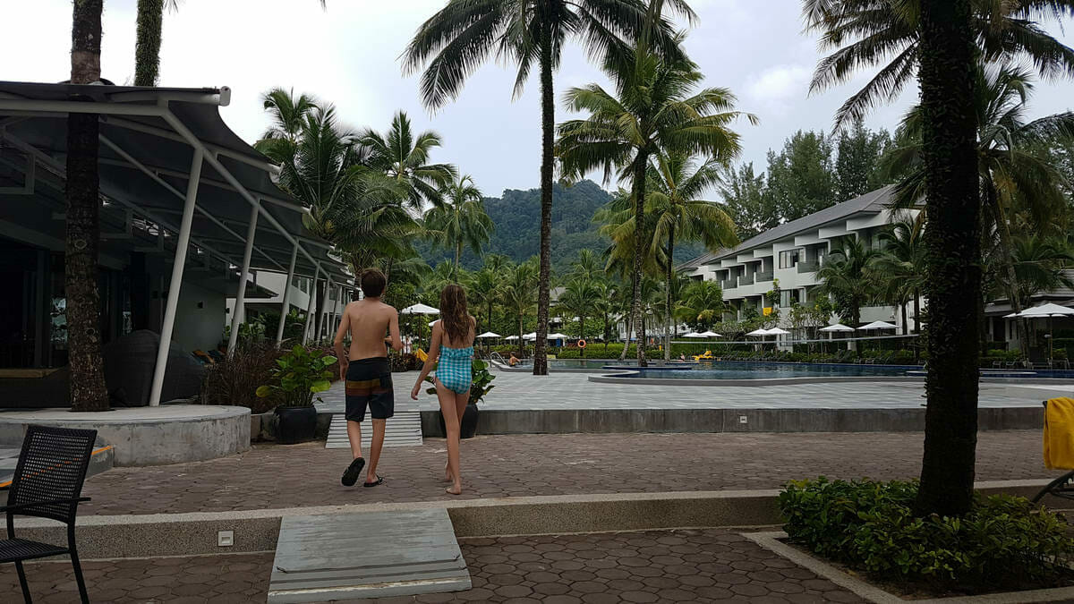 Kids walk towards the pool in a resort in Thailand