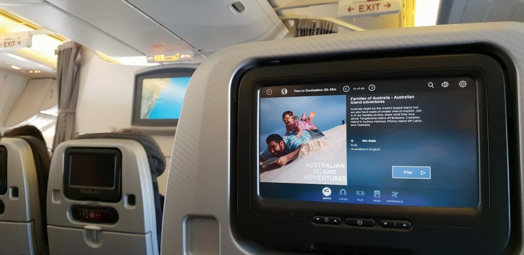 In-flight entertainment screens on seat-backs in plane