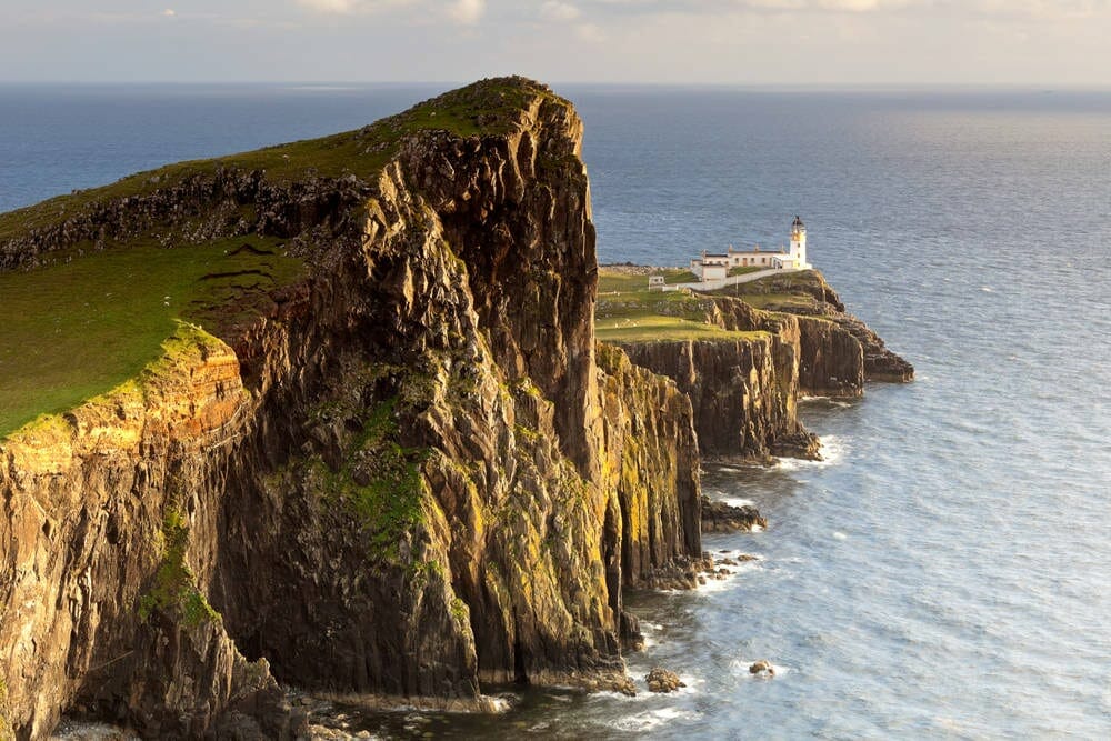 Green clifftops with lighthouse on Isle of Skye