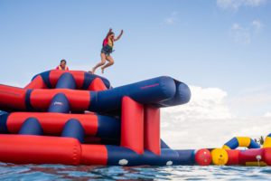 A child jumps off inflatable water park