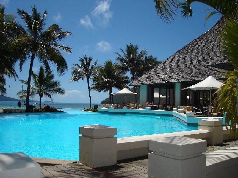 Pool, cabana and palm trees at Hamilton Island resort