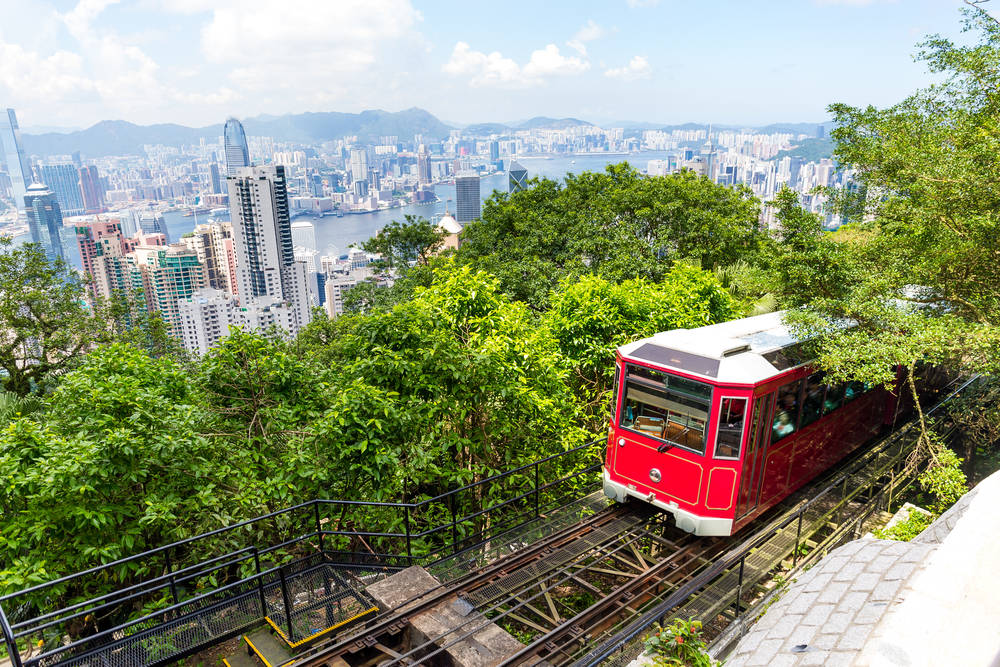Tram on top of Victoria Peak with views of Hong Kong skyline