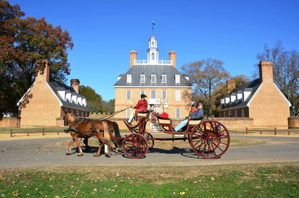 Horse and carriage pass Governor's building in Colonial Williamsburg