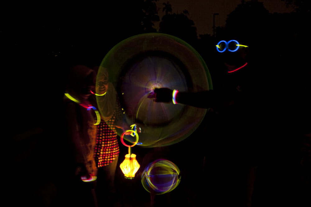 Kids playing with glow sticks at night