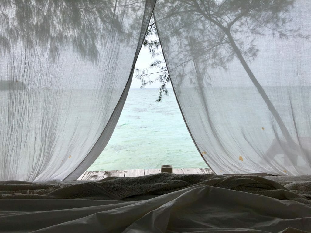 Morning view through curtains on Pulau Macan in Thousand Islands