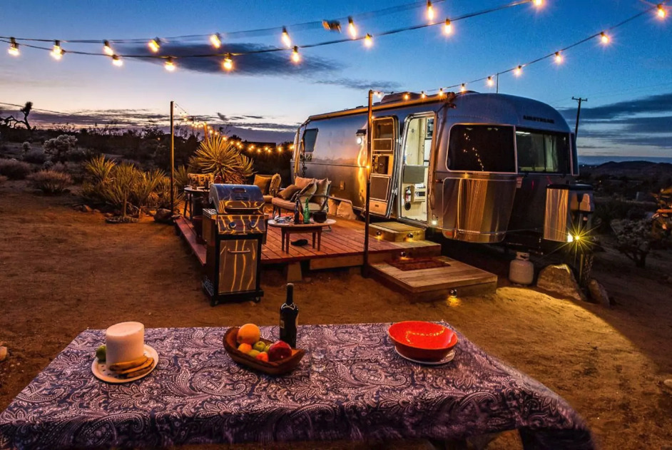 Night-time shot of campervan Airbnb for families in desert, California