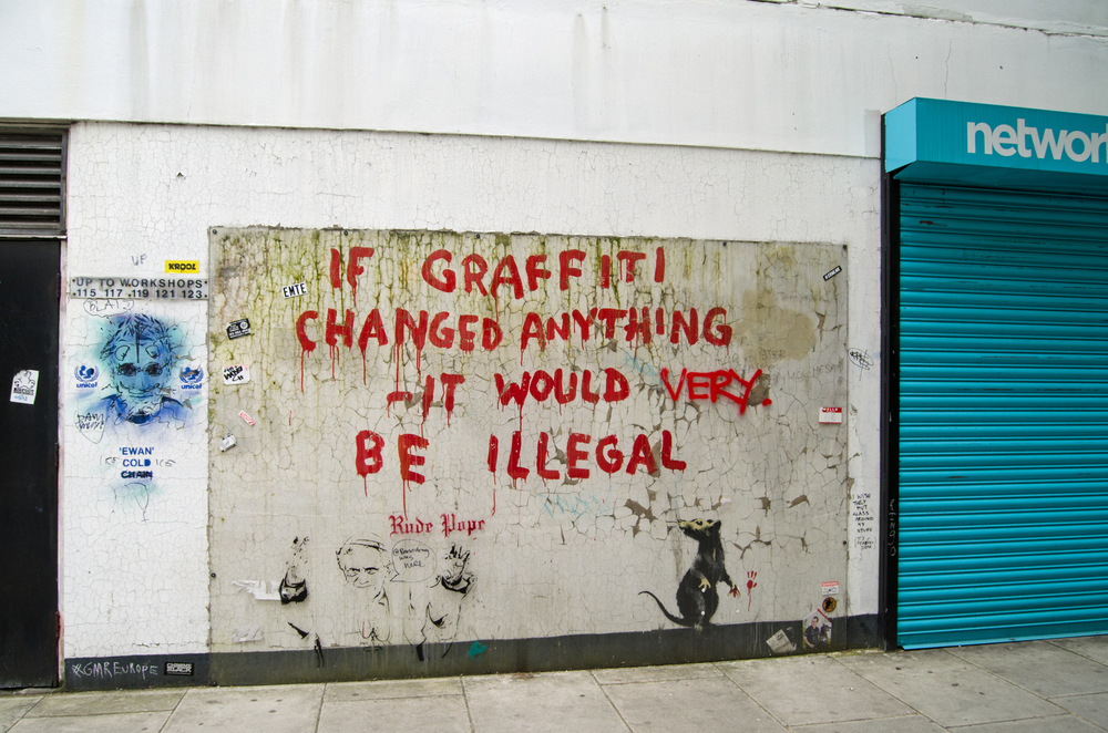 British artist Banksy painted on the side of a wall in Westminster, Central London