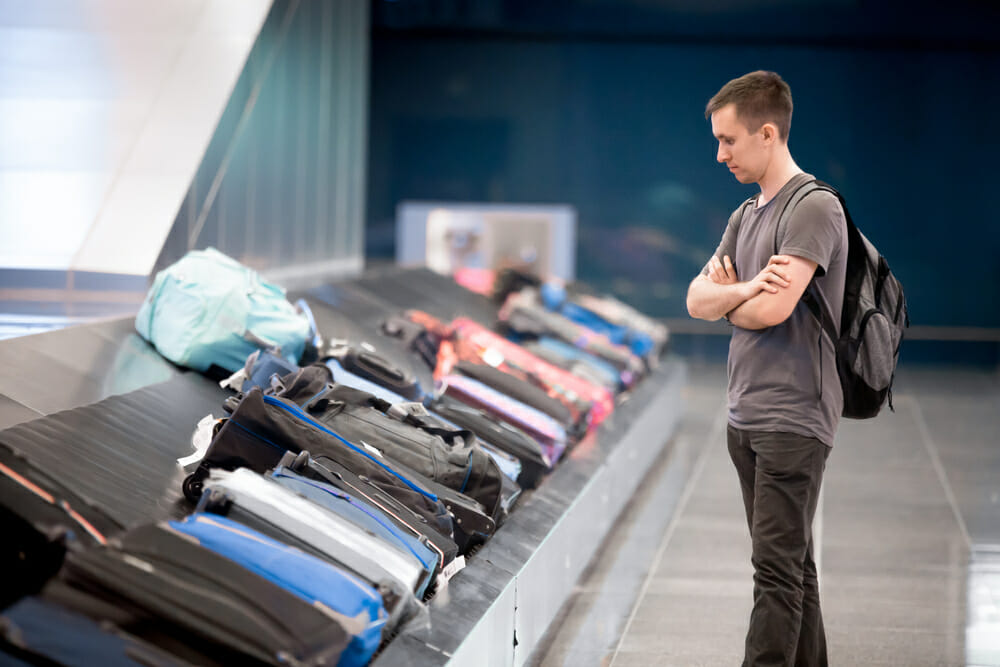 Man standing at baggage claim in airport