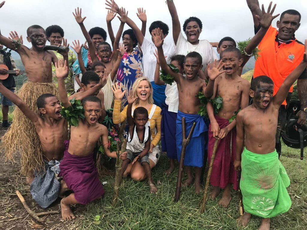 Tourist posing with group of locals in Fiji
