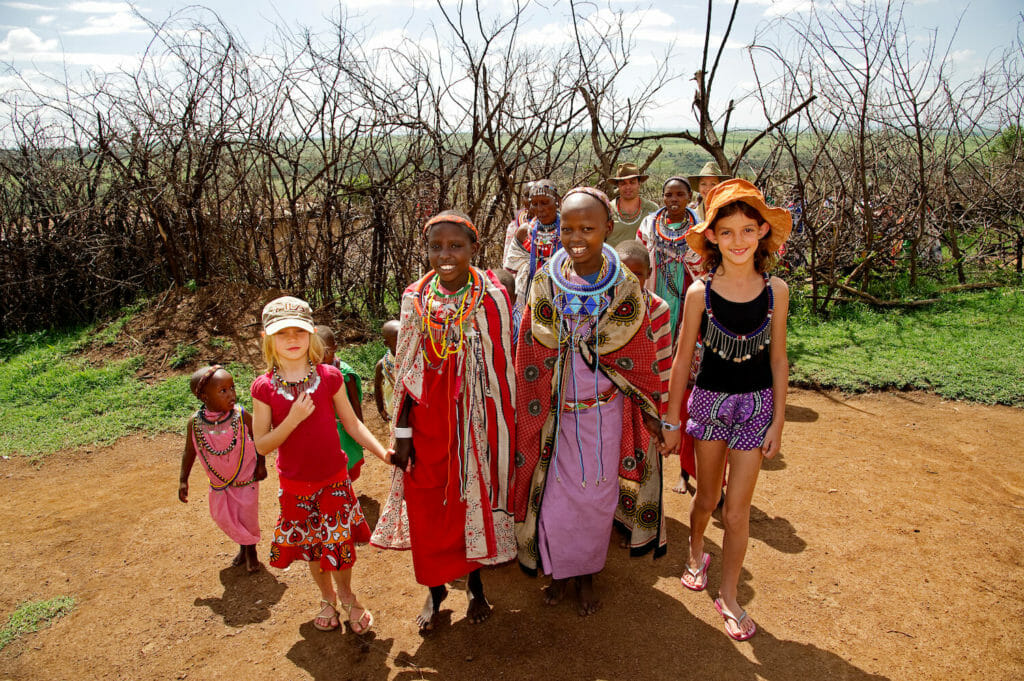 Young tourists meeting the local village children in Kenya, Africa