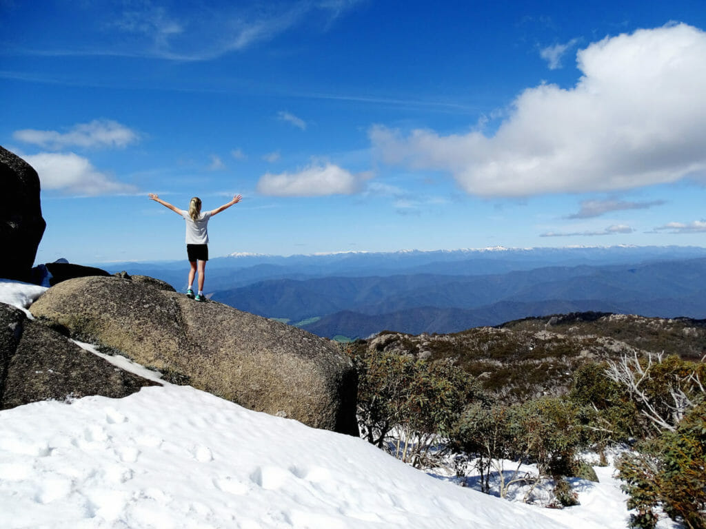 Girl standing on edge of mountain in victoria alpine region