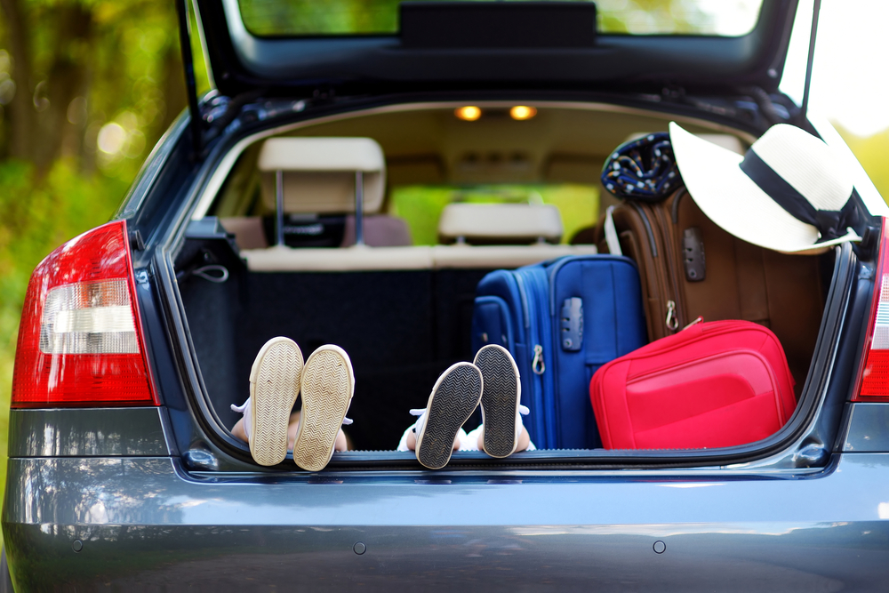 luggage and feet in the boot of a car