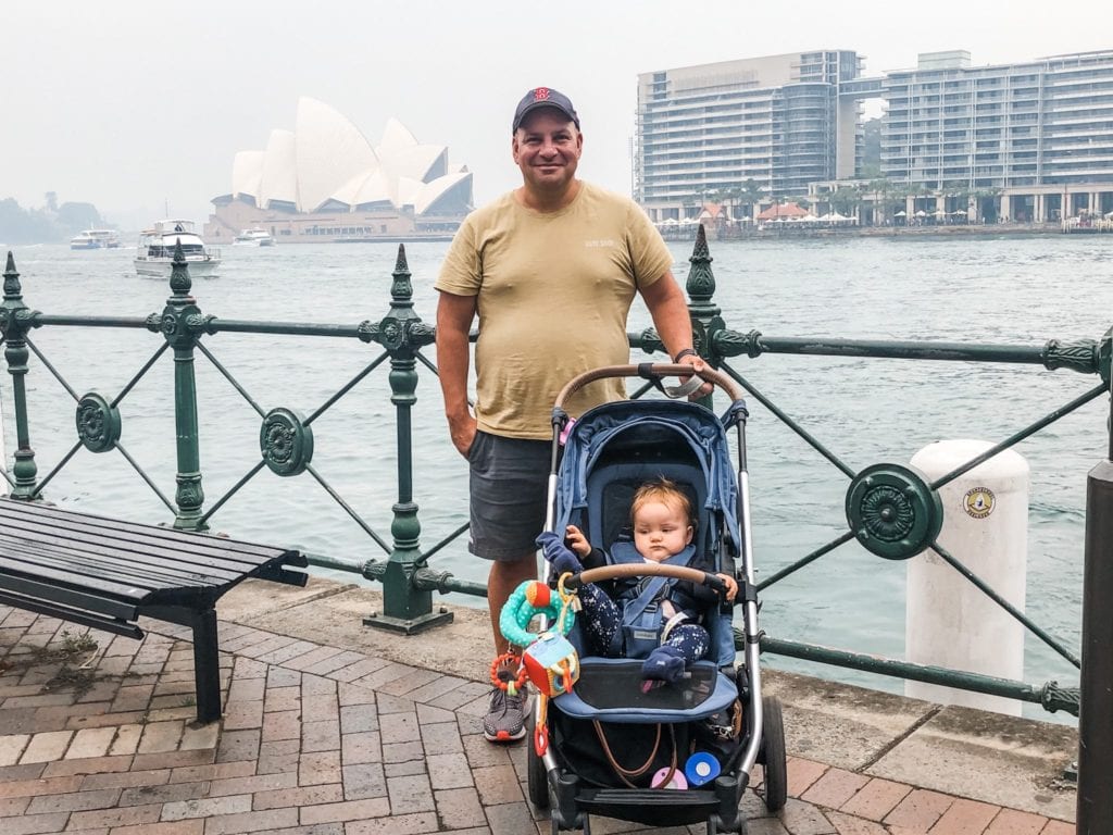 Man and baby in a pram at Circular Quay Sydney with smoke haze