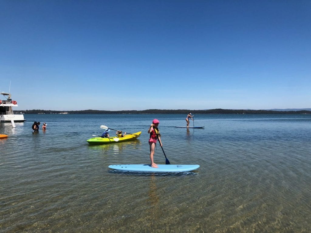 kids enjoying SUP and kayaking on Lake Macquaire