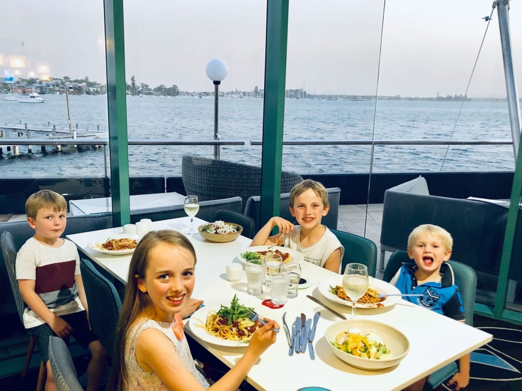 kids enjoying dinner with water views at Belmont 16s