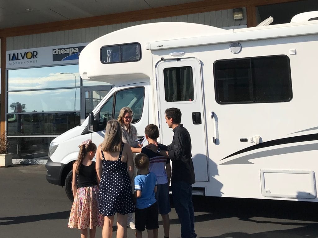 family collecting the keys to an Apollo motorhome