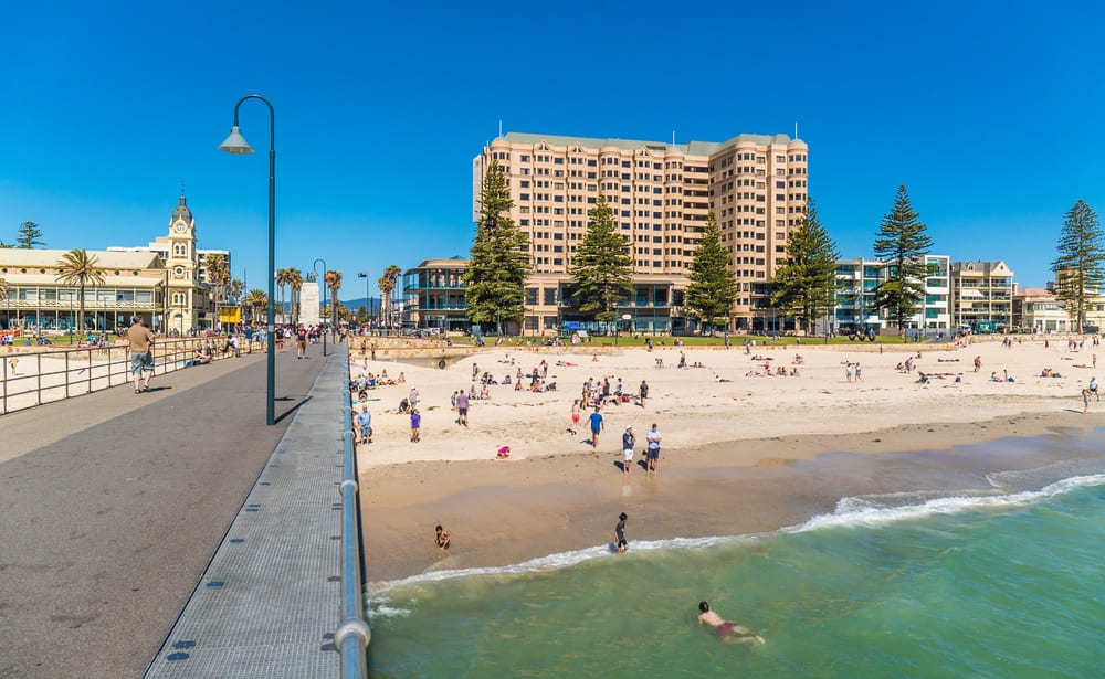 People swimming and lying in the sun on Glenelg beach