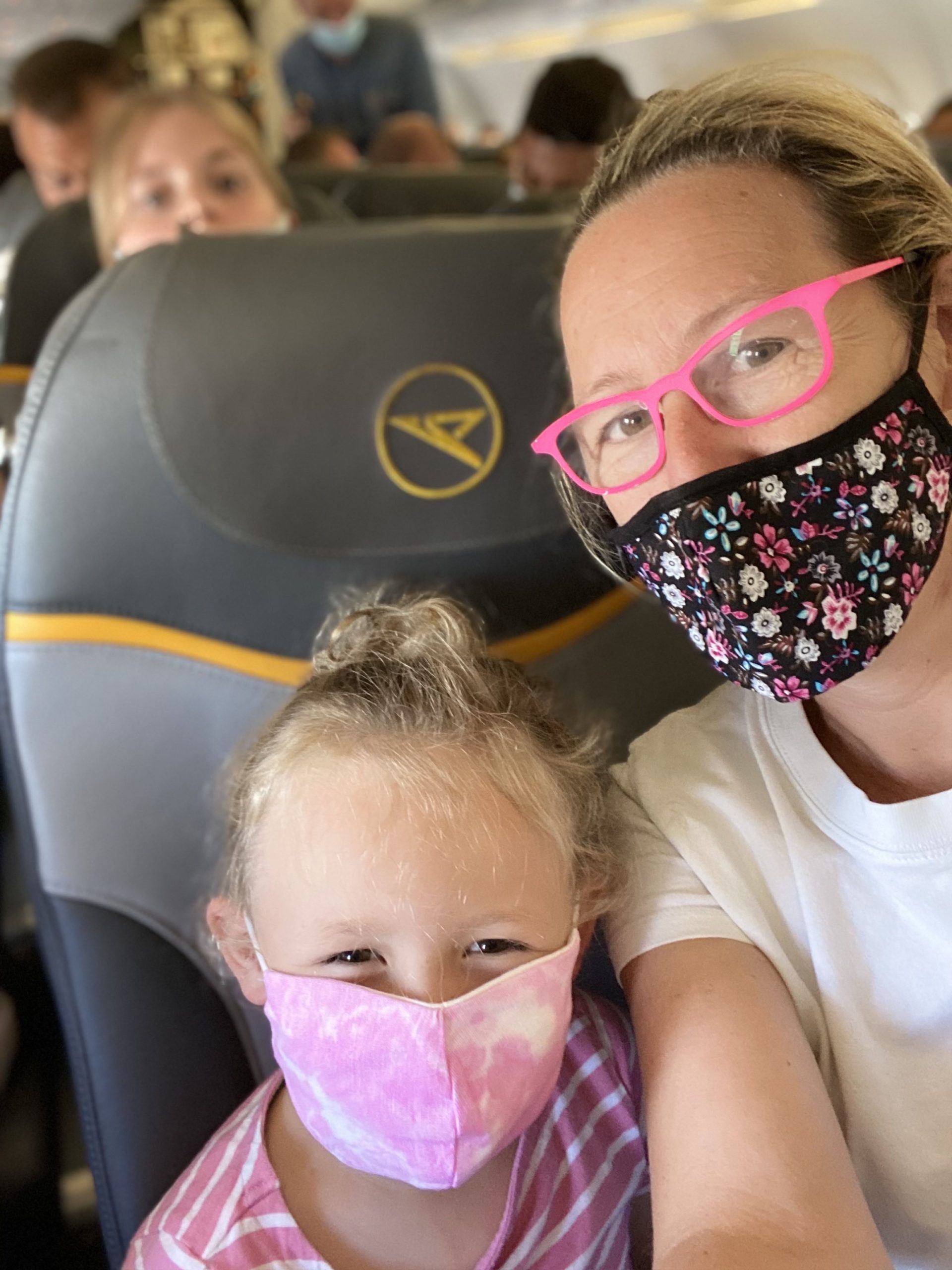 mother & daughter with face mask on Condor flight