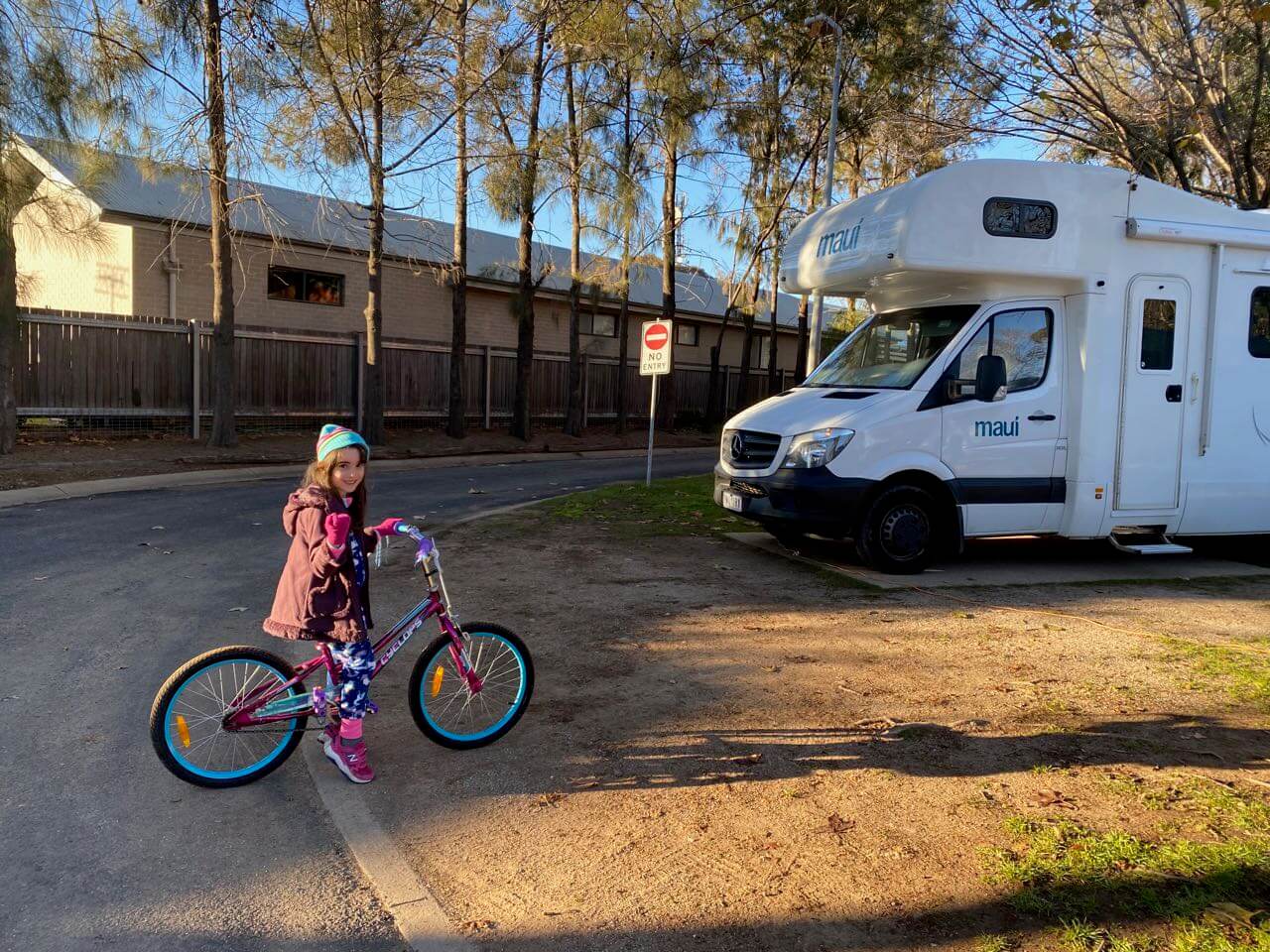 Maui campervan with young girl on a bike