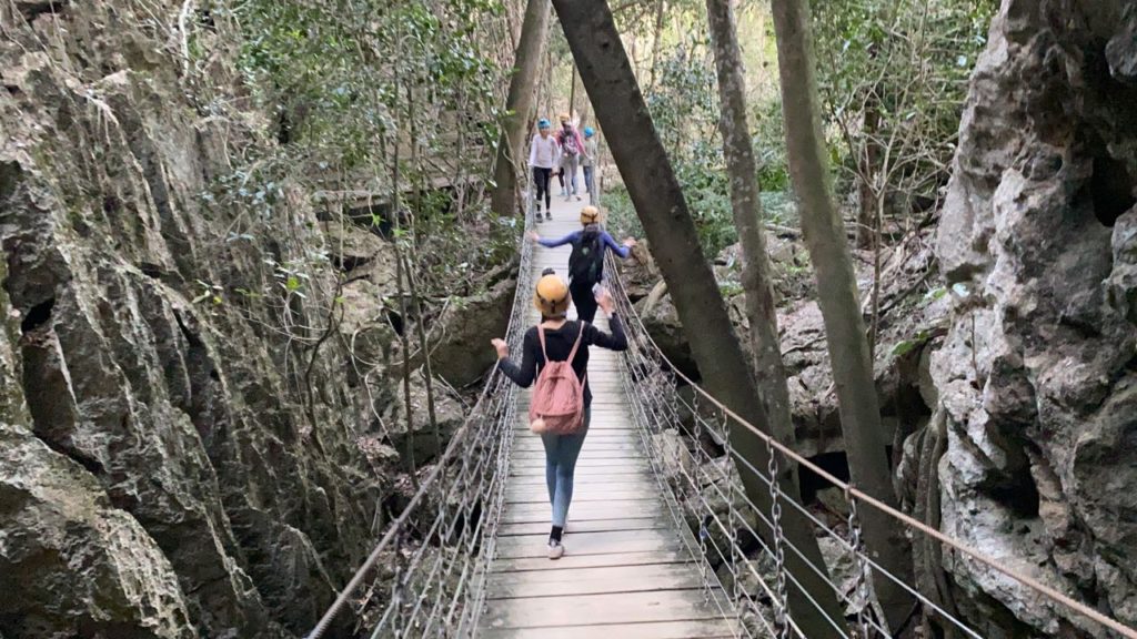 Kids crossing the suspension bridge at Capricorn Caves