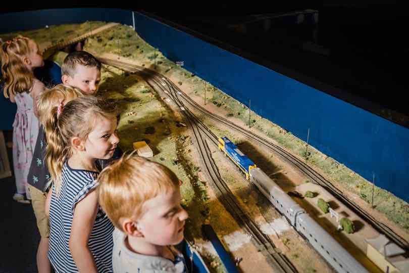 young children watching at train run on the tracks of the miniature railway at the Bathurst Rail Museum