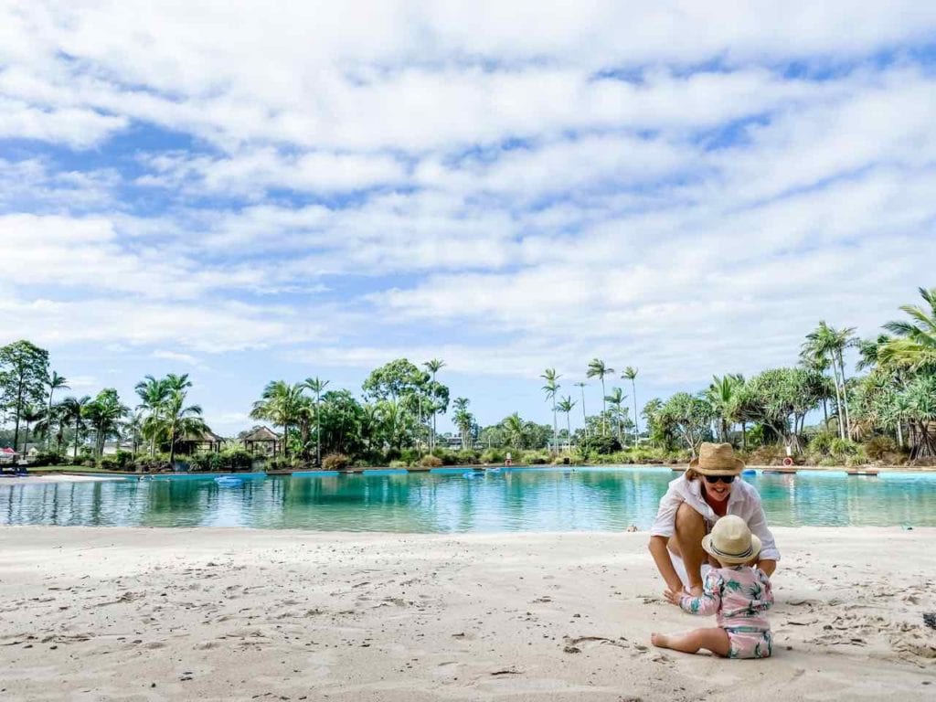 mother and small child on the edge of the lagoon beach pool, one of Australia's best hotel pools, at the Intercontinental Sanctuary Cove