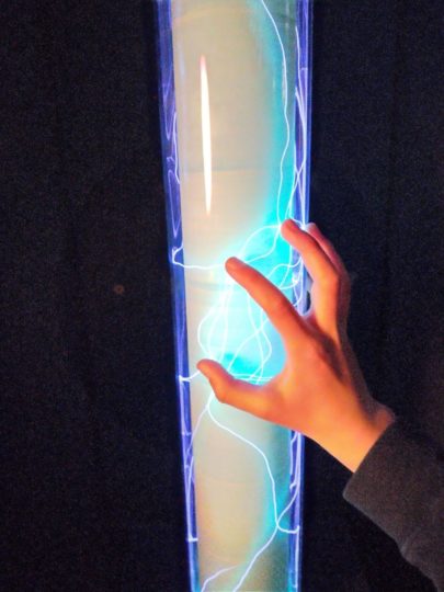 Child's hand touching the plasma tubes at Camera Obscura in Edinburgh